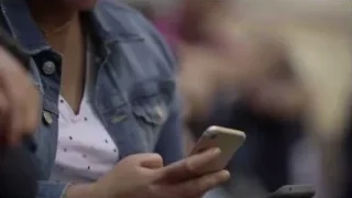 person holding two smartphones — Screened Out