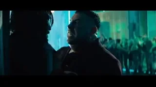 Man and woman in tense conversation with neon lights — John Wick: Chapter 4