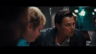 two men talking in dimly lit room — The Wolf Of Wall Street