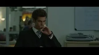 Young man in suit sitting at office desk — The Social Network