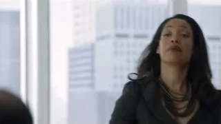 woman standing by window with city skyline — Suits