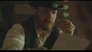 man in black hat reading paper at table — Peaky Blinders