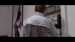 Man in room with bookshelf — American Psycho