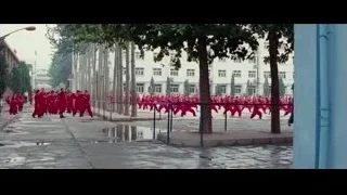 People in red uniforms walking on street — The Karate Kid