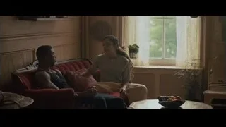 Man and woman conversing on red couch — Creed 2