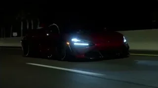 red sports car driving on highway at night — Sports Cars