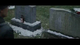 Person standing in snowy cemetery — Creed 2