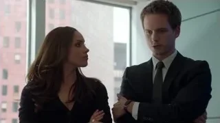 man and woman conversing in office — Suits