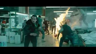 man with gun in burning garage — Deadpool 2