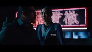 young man in suit in dimly lit room with neon lights — John Wick: Chapter 4