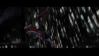 person suspended from high-rise building at night — The Amazing Spider Man