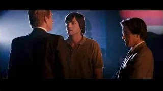 Three men conversing in dimly lit room — Jobs