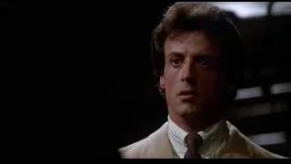 man in beige suit with serious expression — Rocky III