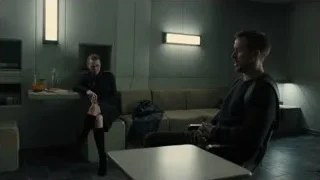 man and woman in dimly lit waiting area — Blade Runner 2049