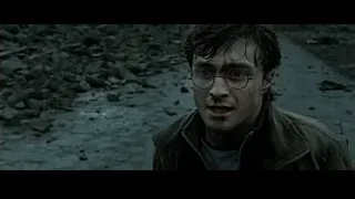 Daniel Radcliffe standing in muddy area — Harry Potter and the Deathly Hallows 2