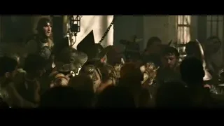 People in medieval armor shouting in tavern — Gladiator 2