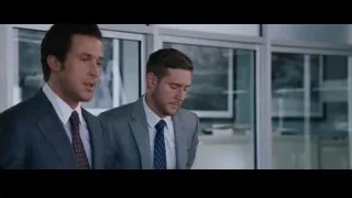 two men in suits in office with city view — The Big Short