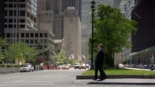 two men in suits talking on city street — Suits