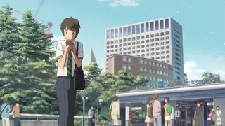 Young man on bridge looking at phone — Your Name