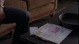 person writing at table with papers — Breaking Bad