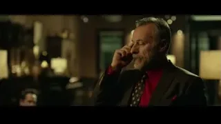 man holding phone to ear in bar — John Wick