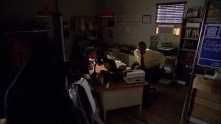 man in yellow shirt adjusting tie in workspace — Breaking Bad