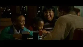 family sitting at restaurant table — The Persuit of Happyness
