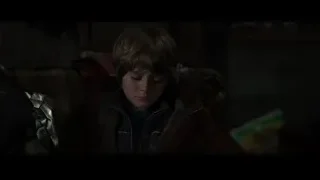 Young boy deep in thought with robotic arm — Iron Man 3
