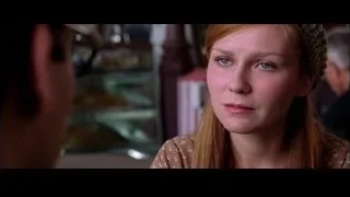 woman with green headband talking to man — Spider Man 2
