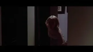 Person holding flashlight in dimly lit room — American Psycho