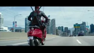 man riding red scooter on highway — Deadpool 2