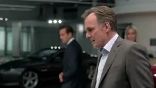 men in suits in car showroom — Suits