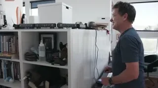 man smiling at model train on shelf — Elon Musk: Return to Space