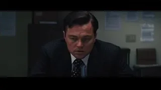 man in suit deep in thought at desk — The Wolf Of Wall Street