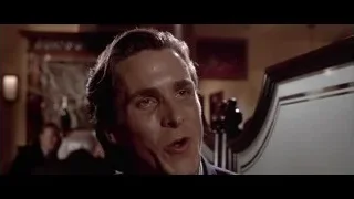 man in suit smiling at bar — American Psycho