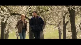 Man and woman standing by flowering trees — Doctor Strange 2