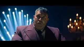 Man in suit holding playing card — John Wick: Chapter 4
