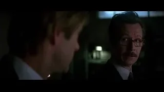 two men facing each other in dimly lit room — Batman: The Dark Knight