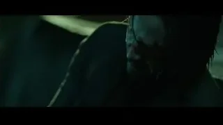 Bloody person with eyes closed in dark setting — John Wick