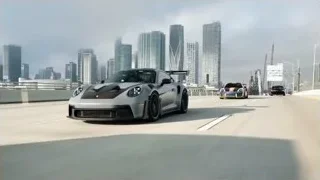 sports car driving on highway with city skyline — Sports Cars