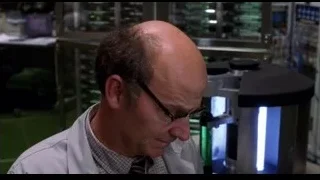 Man in lab coat looking through microscope — Spider Man