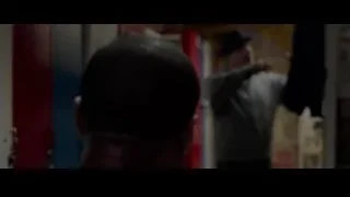 man in grey hoodie with posters — Creed