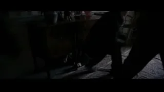 dimly lit room with wooden dresser and chair — Batman: The Dark Knight Rises