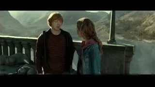 Young couple on balcony overlooking mountains — Harry Potter and the Deathly Hallows 2