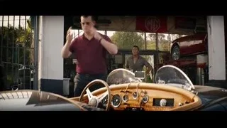 Man looking at vintage car dashboard in garage — Ford v Ferrari