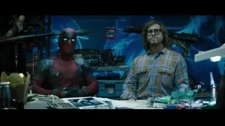 Deadpool holding gun in cluttered room — Deadpool 2