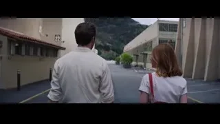 man and woman walking down street — La La Land