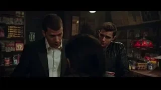 three men conversing in dimly lit room — Now You See Me 2