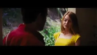 woman in yellow dress talking to man — La La Land
