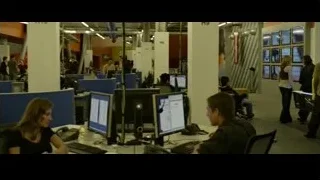 people working in open-plan office — The Social Network